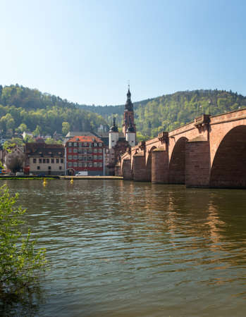Medieval bridge leading into old town of Heidelberg Germany from riverbank of River Neckarの写真素材