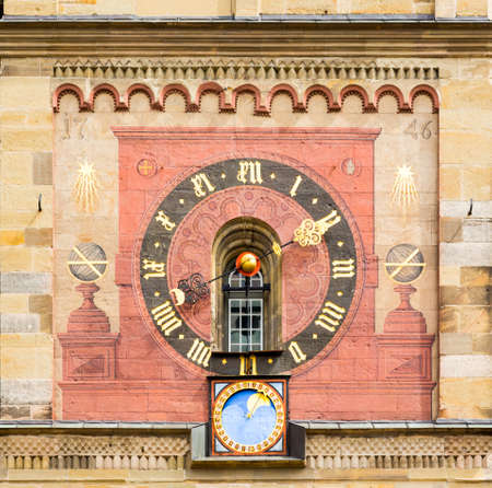 Detail of the 1746 church clock and astronomical phases of moon on medieval church of St Michael in the town square of Schwabisch Hall in Germanyの写真素材