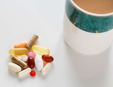 Collection of different colors and sizes of vitamins and supplements taken with breakfast for healthy lifestyleの写真素材