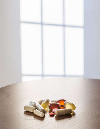 Collection of different colors and sizes of vitamins and supplements taken with breakfast for healthy lifestyleの写真素材