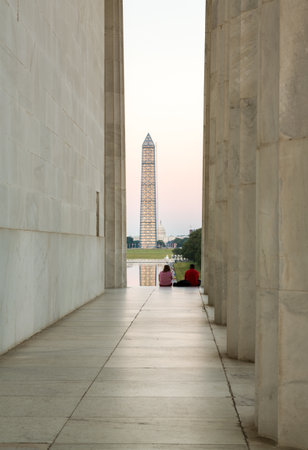 WASHINGTON, DC - JULY 29: Washington Monument encased in 500 tons of scaffolding to repair damage on 29 July 2013. Tourists visit to see tower illuminated by Reflecting Pondのeditorial素材