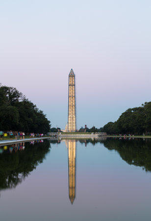 WASHINGTON, DC - JULY 29: Washington Monument encased in 500 tons of scaffolding to repair damage on 29 July 2013. Tourists visit to see tower illuminated by Reflecting Pondのeditorial素材