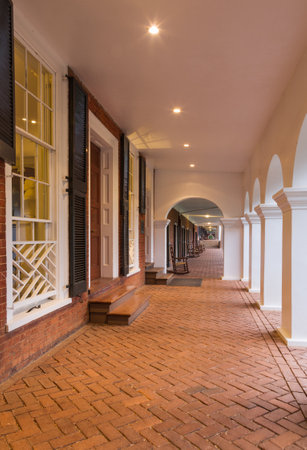 CHARLOTTESVILLE, VA - AUGUST 28: Rocking chairs in the walkway under portico on the campus of...