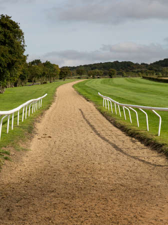 Horse riding stables for training race horses in Cotswold or Cotswolds district of southern England in the autumn.の写真素材