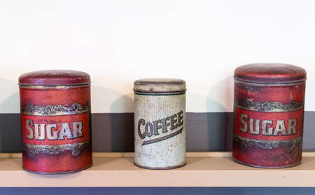 Three tins on shelf in pantry holding coffee and sugar from victorian eraの写真素材