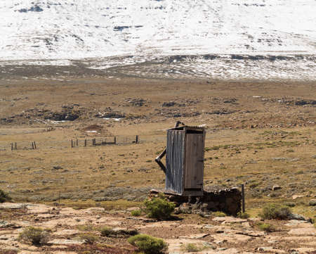 Isolated lonely restroom toilet over mountains from South Africa to Lesotho over Sani Passの写真素材