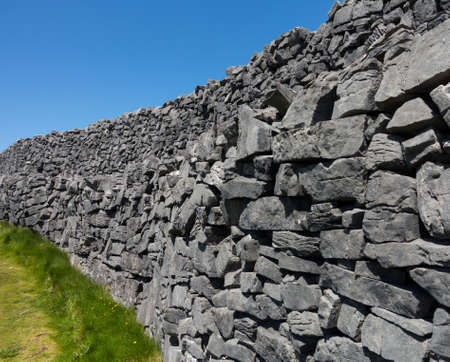 Dun Aonghasa or Dun Aengus is the most famous of several prehistoric forts on the Aran Islands of County Galway, Ireland. It is on Inishmore, at the edge of an 100 metre high cliffの写真素材
