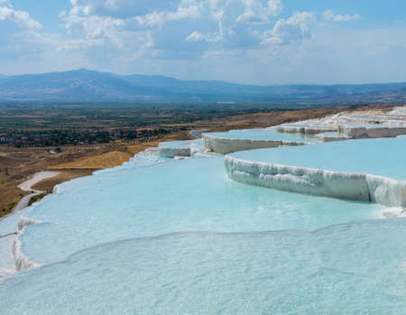 Hot springs create cascades and travertines of calcium running down hillside in Pamukkale in Turkeyの写真素材