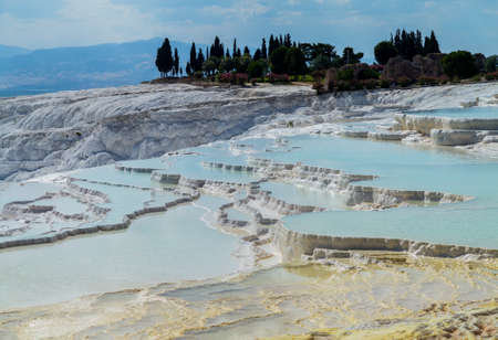 Hot springs create cascades and travertines of calcium running down hillside in Pamukkale in Turkeyの写真素材