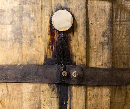 Macro close up shot of the wooden bung or cork in a barrel of oak used for holding bourbon whisky