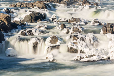 Great Falls on Potomac river outside Washington DC in winter with ice forming on the cascades and snow on the rocksの写真素材