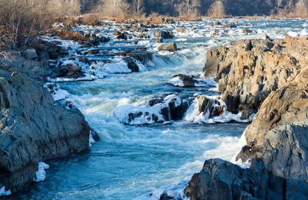 Great Falls on Potomac river outside Washington DC in winter with ice forming on the cascades and snow on the rocksの写真素材