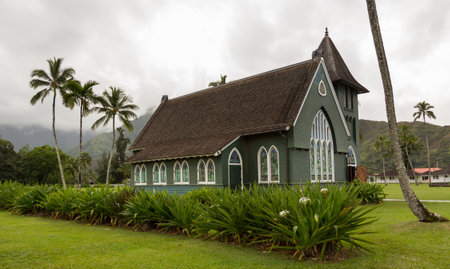 The old Waioli Huiia Mission church building and hall in Hanalei Kauai with the Na Pali Mountains shrouded in mist in the backgroundのeditorial素材