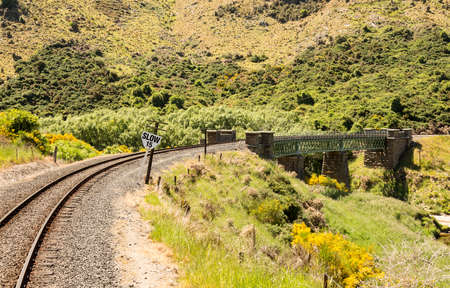 Railway track of Taieri Gorge tourist railway crosses a bridge across a ravine on its journey up the valleyの写真素材