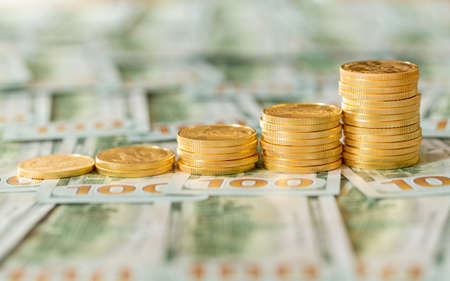 Stack of golden eagle coins in rising price graph or bar chart and standing on new design of US...