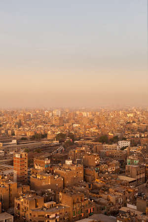Roofs of slum buildings in downtown Cairo showing rubbish and trash on buildings and many satellite dishesの写真素材