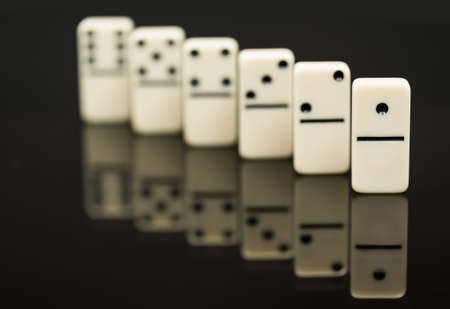 Number One domino in front of peers as concept image for success, innovation, leadership, winning and leader of the packの写真素材