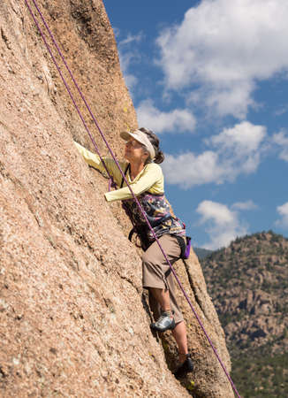Senior female climber on rope assisted climb on Turtle Rocks near Buena Vista Coloradoの写真素材