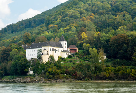 View of Pfarre Schoenbuehel, the parish church of the village on the side of the Danube River near Melk, Austriaのeditorial素材