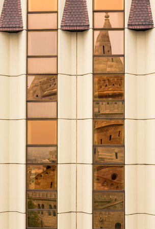 Reflection of old traditional castle turret in front of Hilton Hotel in Castle district of Buda,...