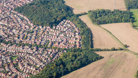 Housing development sprawls near farmland near Luton, Englandの写真素材