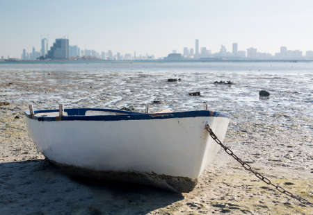 Fishing or fisherman boat on waterside overlooking Manama, Bahrain, Middle Eastの写真素材