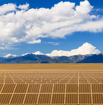 Composite of solar panel power station with mountains and bright blue sky to illustrate power...