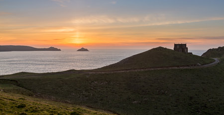 Doyden Castle on headland overlooks the coast at sunset at Port Quin, Cornwall, England, United Kingdomのeditorial素材
