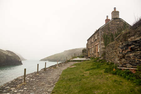 View of harbour or harbor as the mists roll in over the ocean in Port Quin, Cornwall, England, UKの写真素材