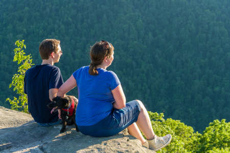 Hikers look at Cheat River Canyon from Raven Rock in Coopers Rock State Forest West Virginiaの写真素材