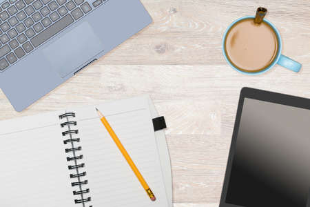 Tidy organized desk top with laptop and electronics with cup of coffee or tea on white wooden table for designer workspaceの写真素材