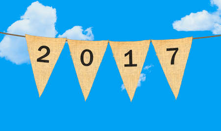 High resolution isolated sack cloth pennants with the letters embossed on each to create pennant flag message of 2017 in the sky for New Year messageの写真素材
