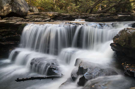 Cascade of waterfall into swimming hole with blurred motion on Deckers Creek running by Route 7 near Masontown in Preston County West Virginiaの写真素材