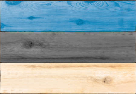 Timber planks of wood that have been painted or stained in the colors of an Estonian flag as a backgroundの写真素材