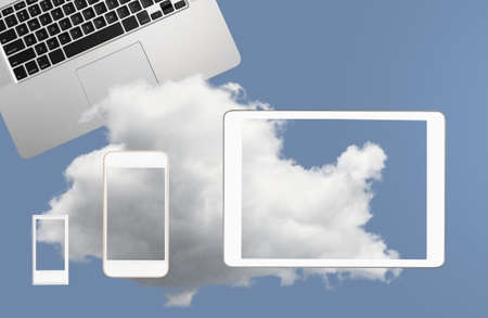 Concept image for cloud computing and online applications showing modern smartphone held in male...