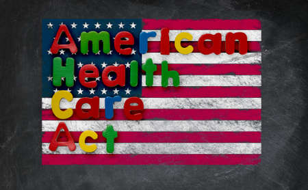 Childs magnetic letters spell American Health Care Act in congress. This is superimposed on a US flag chalked onto a blackboardの写真素材