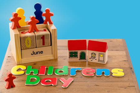 Childs wooden blocks and magnetic letters spell out Childrens Day for June firstの写真素材