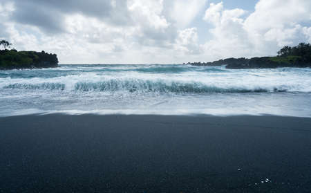 Black sand beach at Waianapanapa State Park on the road to Hana in Maui, Hawaiiの写真素材