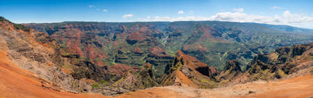 Early light illuminates the steep rock sides of panoramic view of Waimea Canyon on Kauaiの写真素材