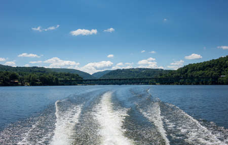 Wake and wash behind speeding boat on Cheat Lake near Morgantown, West Virginiaの写真素材