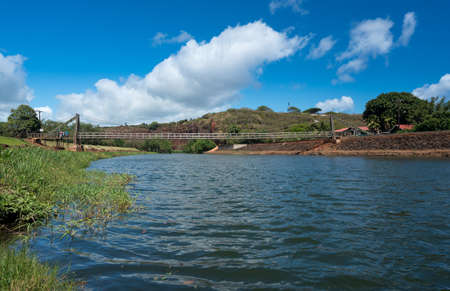 Wide angle view of the famous wooden suspension swinging bridge to cross the river in Hanapepe Kauaiの写真素材