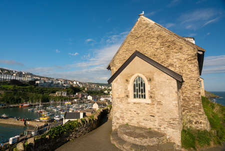 St Nicholas Chapel on the headland above the old harbour of Ilfracombe in North Devon, Englandの写真素材