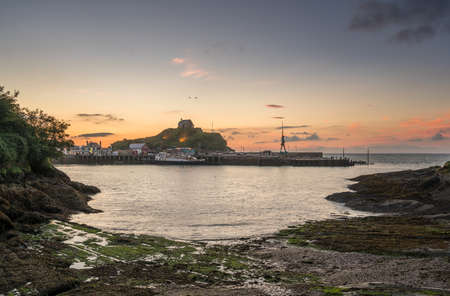 Panorama of the seaside town of Ilfracombe in Devon at sunset with view over harbor and housesの写真素材
