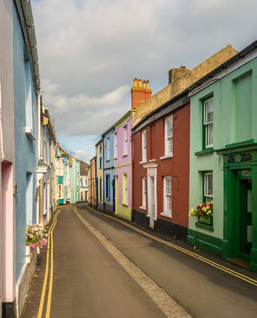 Old stone plaster and painted homes in narrow street in Appledore, Devonの写真素材