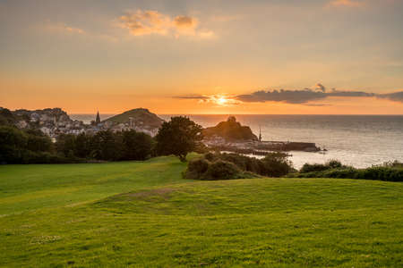 Panorama of the seaside town of Ilfracombe in Devon at sunset with view over harbor and housesの写真素材