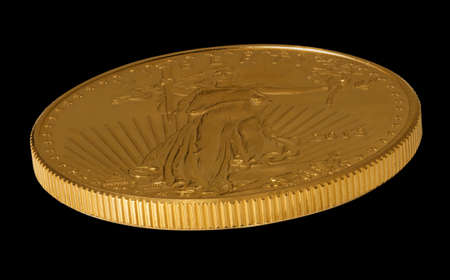 Isolated view of the side of a one ounce gold eagle coin minted in the USAの写真素材