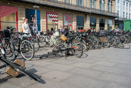 COPENHAGEN, DENMARK - SEPTEMBER 18: Pile of bikes on pavement on September 18, 2017 in Copenhagen. 36% of all citizens commute to work or school by bicycleのeditorial素材