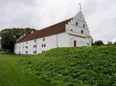 White exterior of Aalborghus Castle in the old town of Aalborg in Denmarkの写真素材