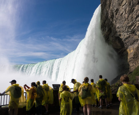 NIAGARA FALLS, CANADA - JUNE 30, 2016: Tourists at the Journey behind the Falls by the Canadian or Horseshoe waterfall  of Niagara Fallsのeditorial素材