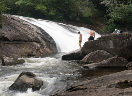 CASHIERS, NORTH CAROLINA - AUGUST 21, 2016: Three boys planning to swim in Turtleback Falls in Gorges State Park near Cashiersのeditorial素材